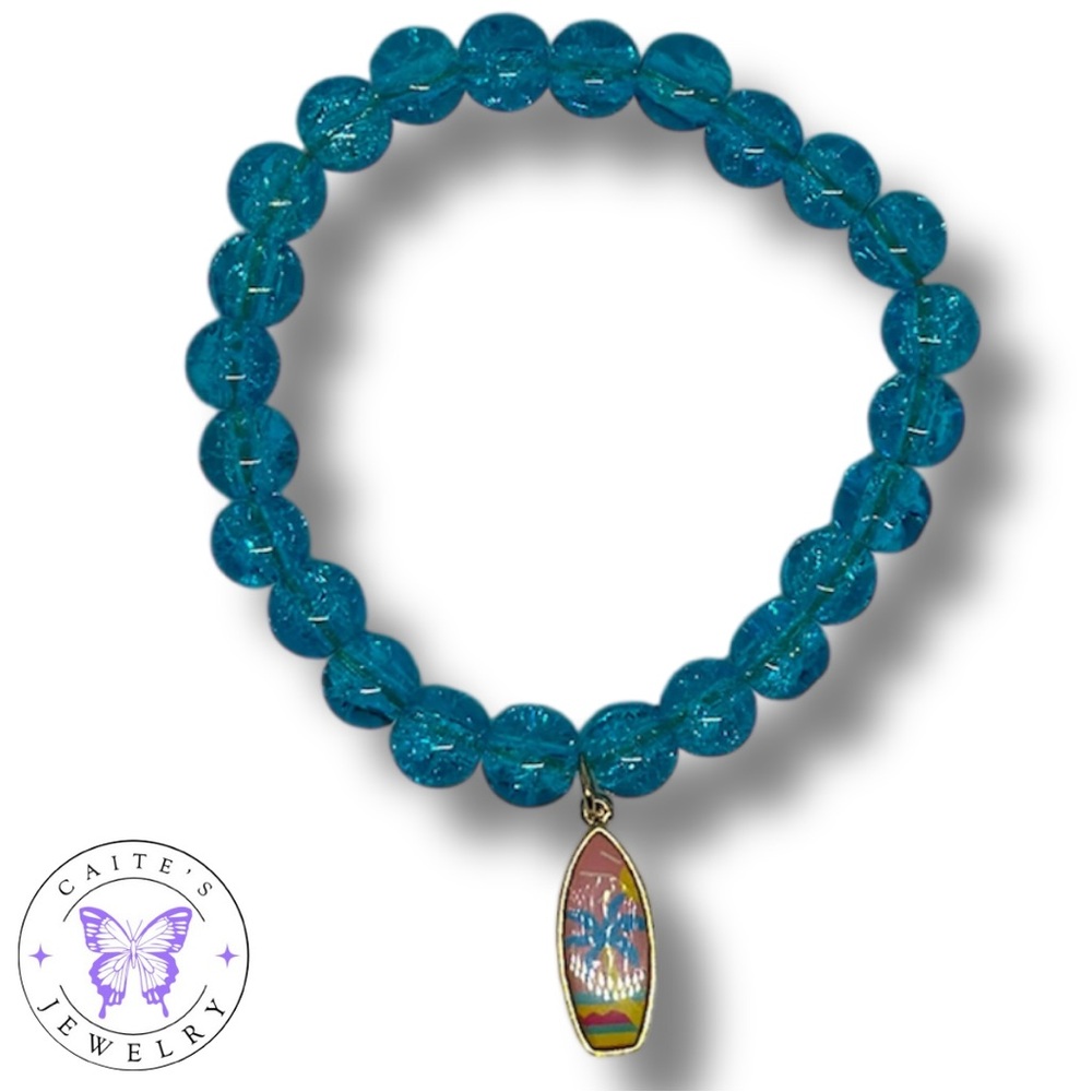 Handmade Gold Elastic Bracelet with Blue Glass Beads and a Surfboard Charm